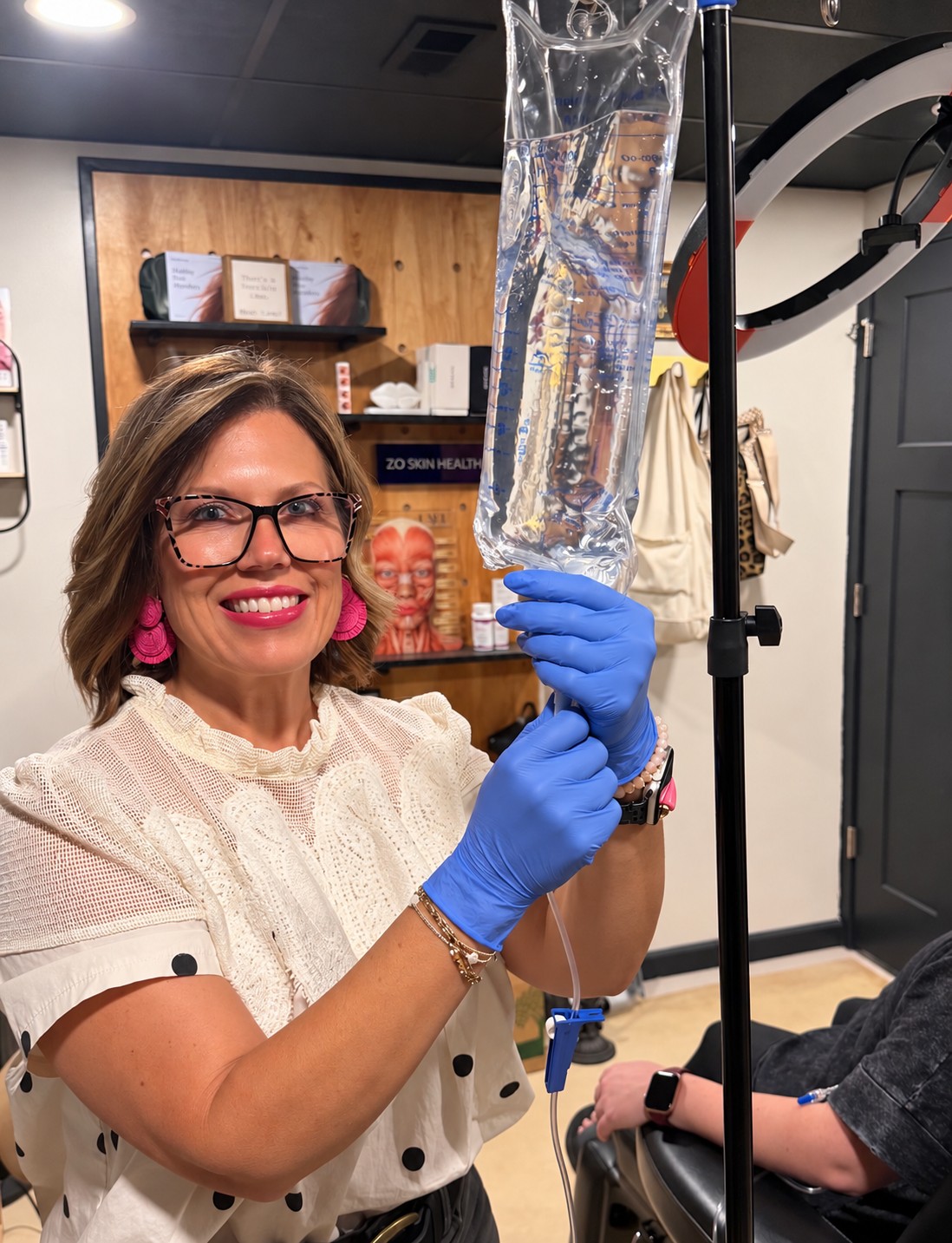 Lael medical provider preparing IV therapy while wearing medical gloves